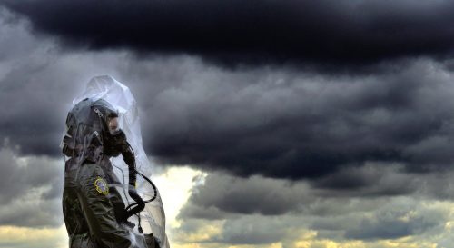Credit: Suited Up by Stuart Rankin. Edited USAF image of a CBRN (chemical, biological, radiological, and nuclear) training exercise. Taken from flickr under creative commons license: Attribution, NonCommercial. 