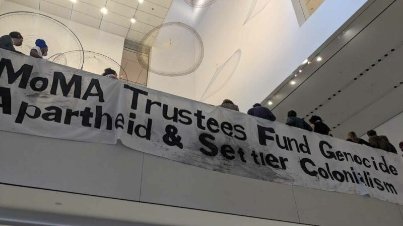 Banner unfurled at the MoMA by peaceful protestors and art-industry workers, February 10, 2024 – Photo Ocean DeRouchie